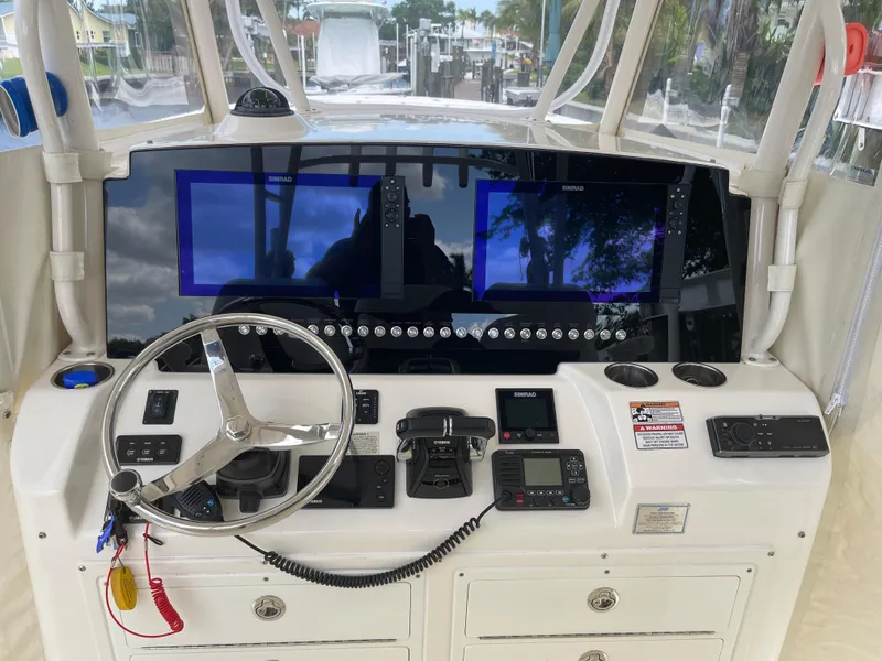 Slide: The Image of 2015 Cobia 344 Center Console helm with dual displays and navigation controls. - 5