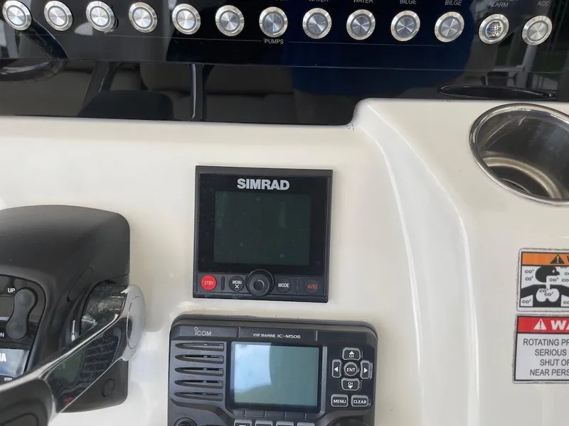 Slide: The Image of 2015 Cobia 344 Center Console dashboard with Simrad and Icom electronics. - 6
