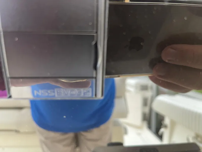 Slide: The Image of Reflection of a person taking a photo on a 2015 Cobia 344 Center Console boat. - 8