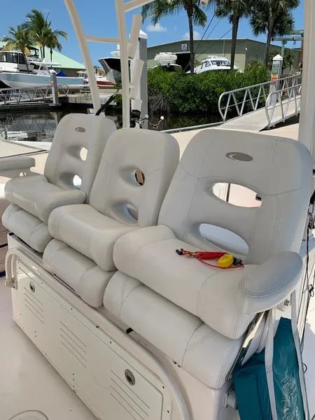 Slide: The Image of 2015 Cobia 344 Center Console boat with white cushioned seating. - 9