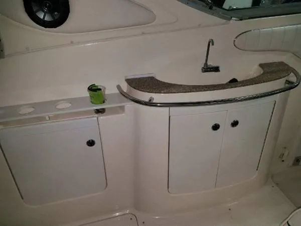 Slide: The Image of 1997 Maxum SCR3000 boat interior with sink and storage cabinets. - 12