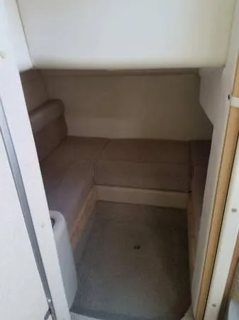 Slide: The Image of 1997 Maxum SCR3000 boat interior cabin with beige seating. - 13