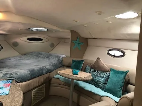Slide: The Image of Interior of 1997 Maxum SCR3000 boat with cozy seating and bed area. - 14