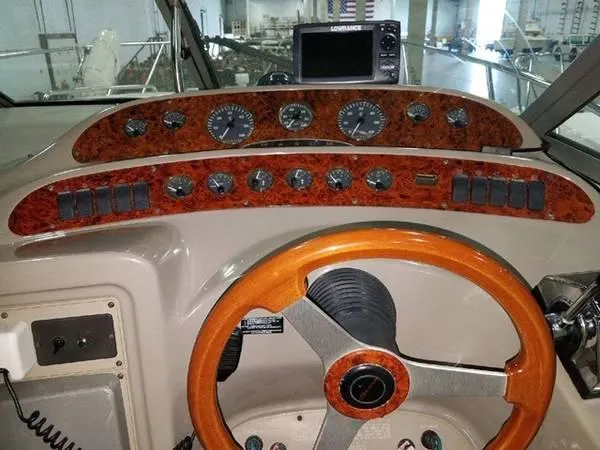 Slide: The Image of 1997 Maxum SCR3000 boat dashboard with wooden steering wheel and instrument panel. - 16