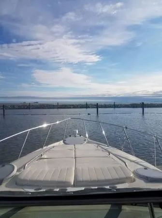 Slide: The Image of 1997 Maxum SCR3000 boat on calm water with a scenic sky. - 4