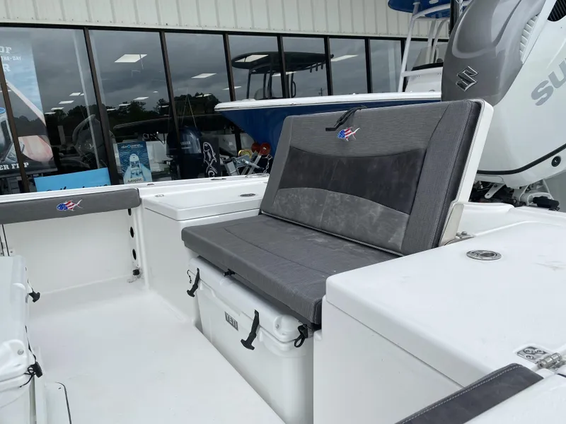 Slide: The Image of 2022 Crevalle 26 HCO boat interior with gray seating and storage compartments. - 10