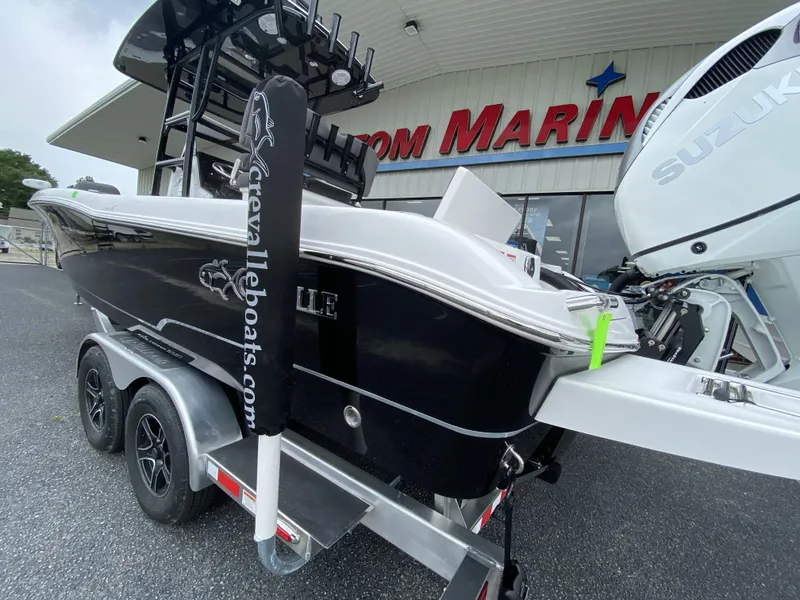 Slide: The Image of 2022 Crevalle 26 HCO boat on a trailer outside a marine dealership. - 18