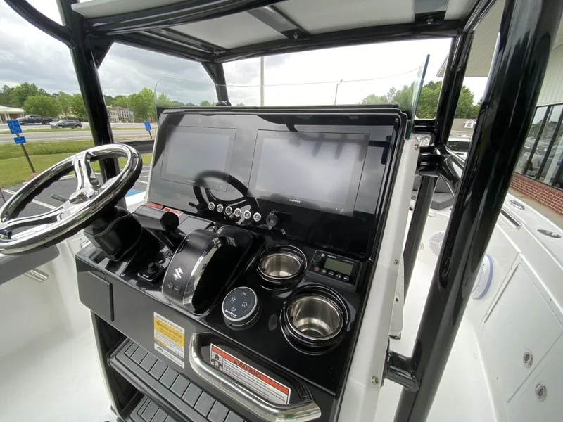 Slide: The Image of 2022 Crevalle 26 HCO boat console with dual screens and steering wheel. - 20