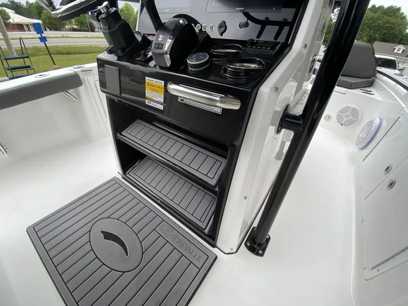 Slide: The Image of 2022 Crevalle 26 HCO boat console with storage compartments and control panel. - 21