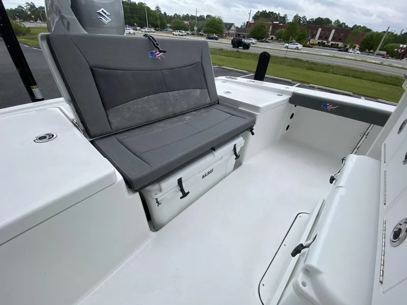 Slide: The Image of 2022 Crevalle 26 HCO boat interior with cushioned seating and storage. - 22