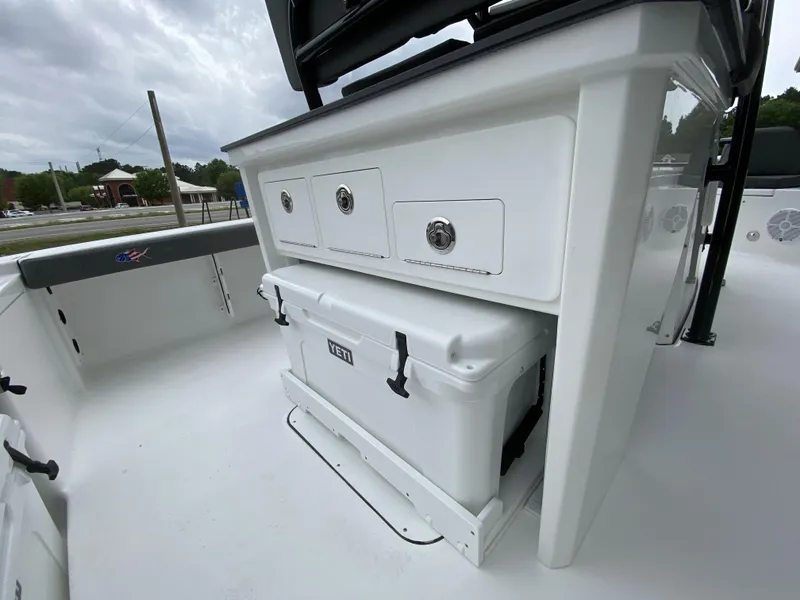 Slide: The Image of 2022 Crevalle 26 HCO boat interior with storage drawers and Yeti cooler. - 23
