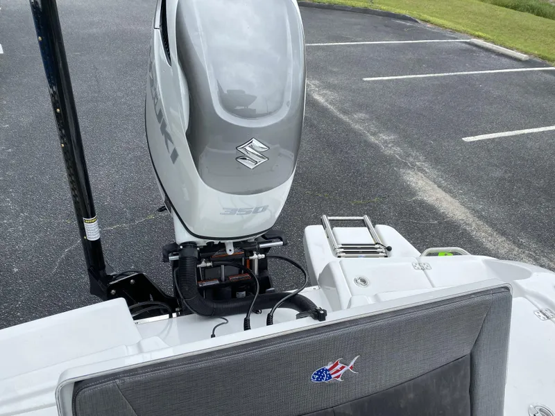 Slide: The Image of 2022 Crevalle 26 HCO boat with Suzuki outboard motor in parking lot. - 27