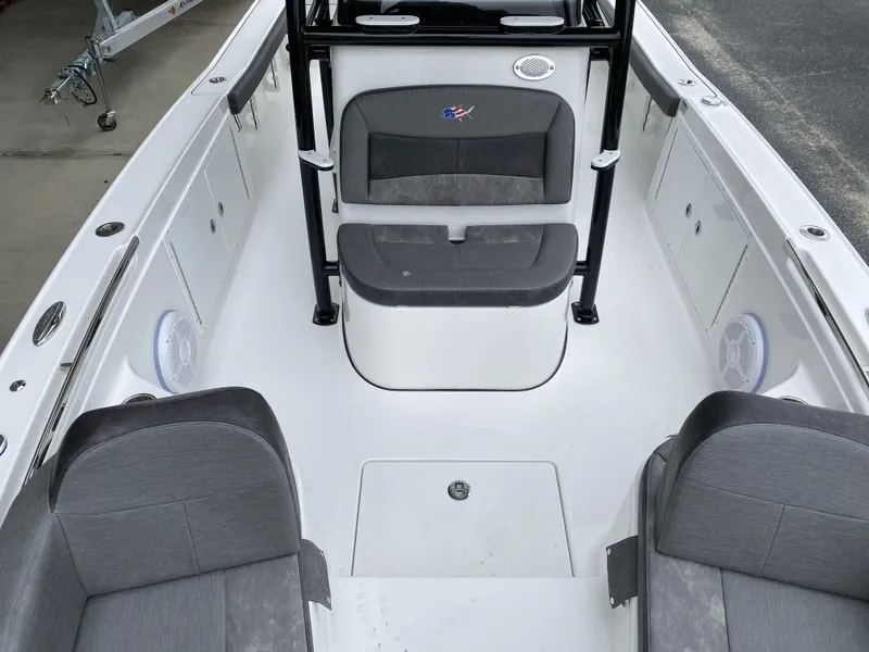 Slide: The Image of 2022 Crevalle 26 HCO boat interior with gray seating and white deck. - 30