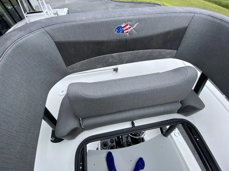 Slide: The Image of 2022 Crevalle 26 HCO boat with gray cushioned seating and American flag fish logo. - 33