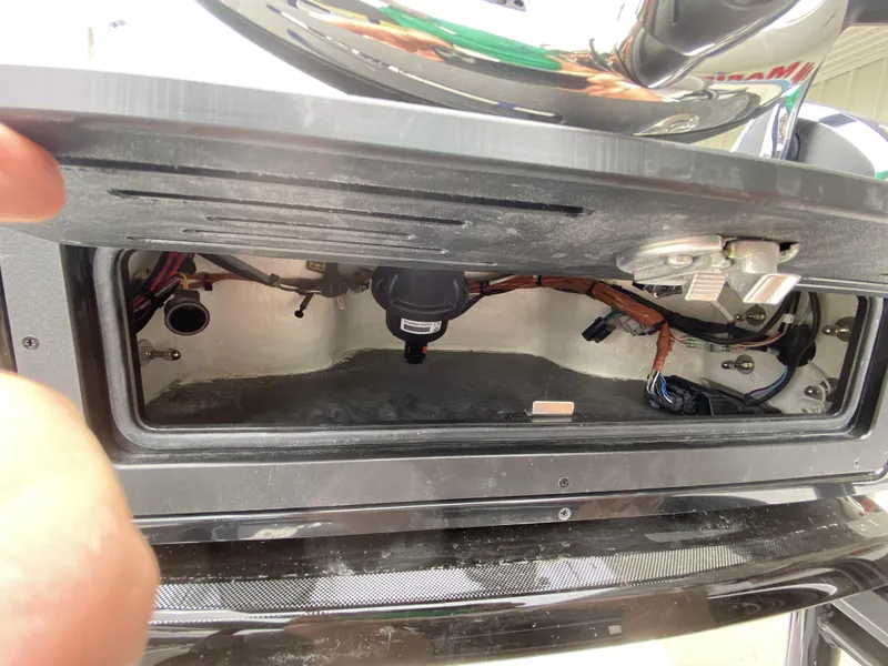 Slide: The Image of 2022 Crevalle 26 HCO boat storage compartment with wiring and components. - 39