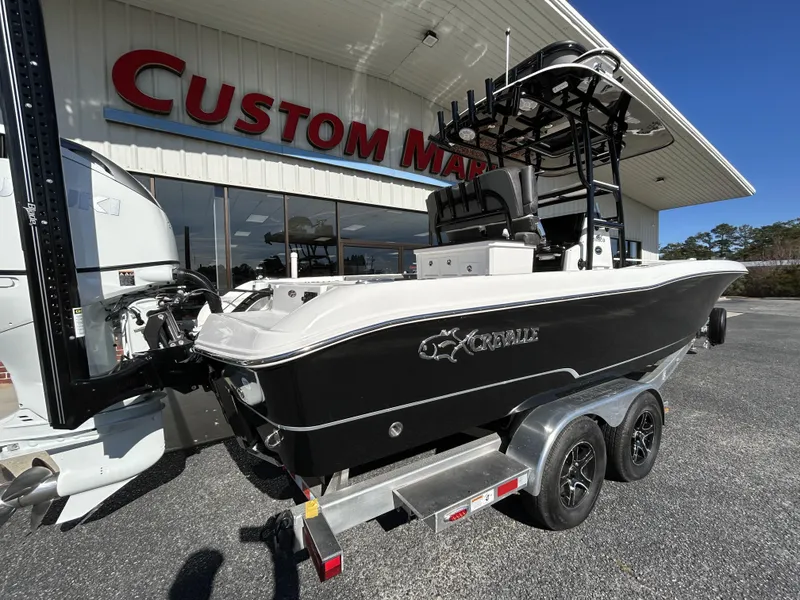 Slide: The Image of 2022 Crevalle 26 HCO boat on a trailer outside Custom Marine dealership. - 43