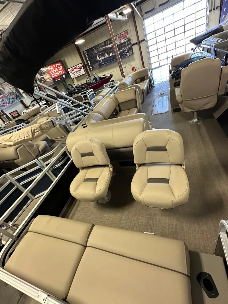 Slide: The Image of 2022 Sun Tracker SportFish 22 XP3 pontoon boat interior with beige seating. - 2