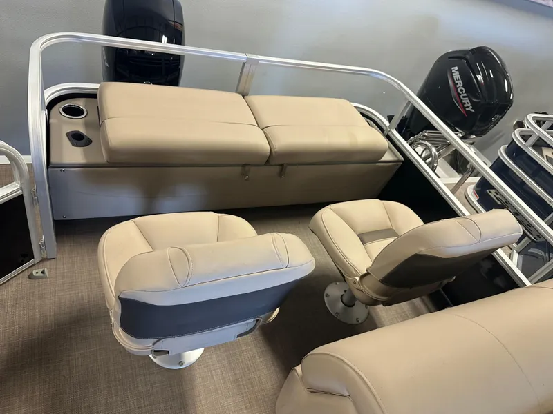 Slide: The Image of 2022 Sun Tracker SportFish 22 XP3 boat interior with beige seating and Mercury outboard motors. - 3