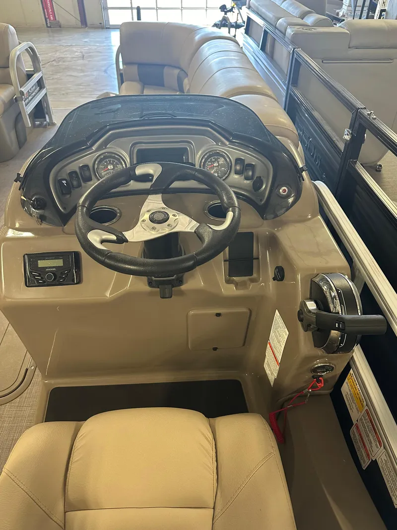 Slide: The Image of 2022 Sun Tracker SportFish 22 XP3 boat dashboard and steering wheel. - 4