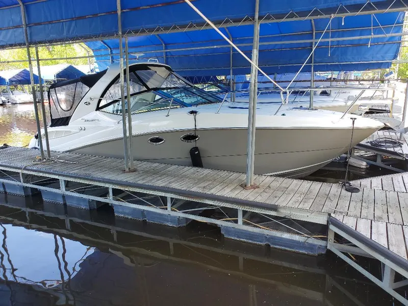 Slide: The Image of 2007 Sea Ray 290 Sundancer docked under blue canopy at marina. - 1