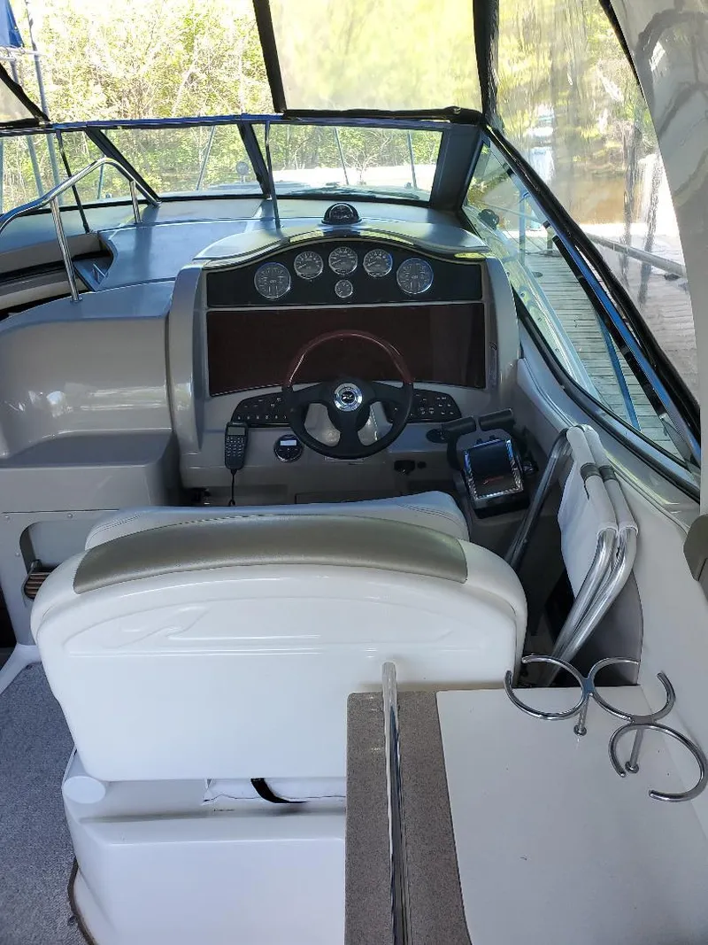 Slide: The Image of 2007 Sea Ray 290 Sundancer boat cockpit with steering wheel and dashboard controls. - 10