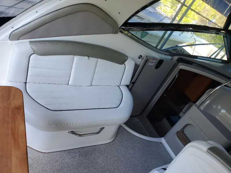 Slide: The Image of Interior of a 2007 Sea Ray 290 Sundancer boat, featuring white seating and modern design. - 11