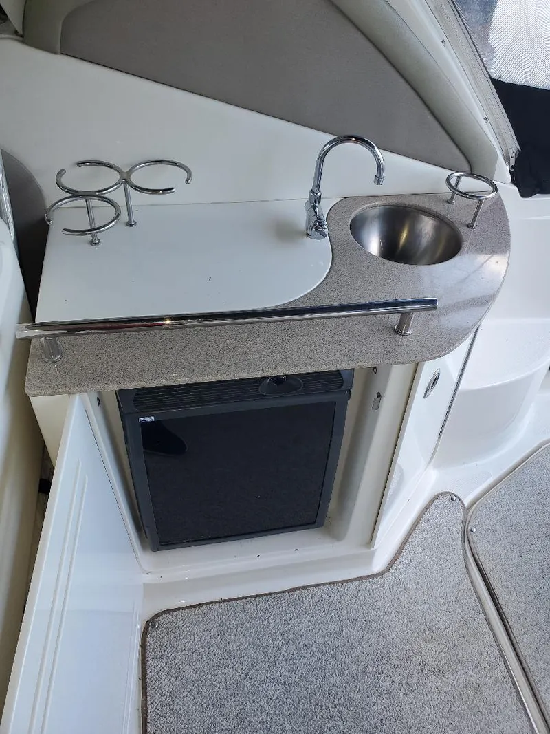 Slide: The Image of 2007 Sea Ray 290 Sundancer kitchenette with sink and mini fridge. - 13