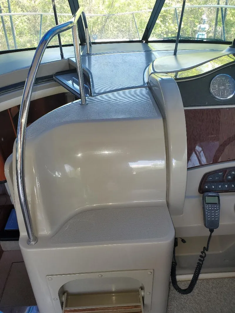 Slide: The Image of 2007 Sea Ray 290 Sundancer helm with control panel and radio. - 16