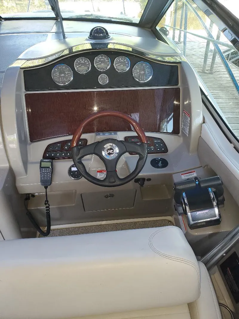 Slide: The Image of 2007 Sea Ray 290 Sundancer helm with wood accents and modern controls. - 20