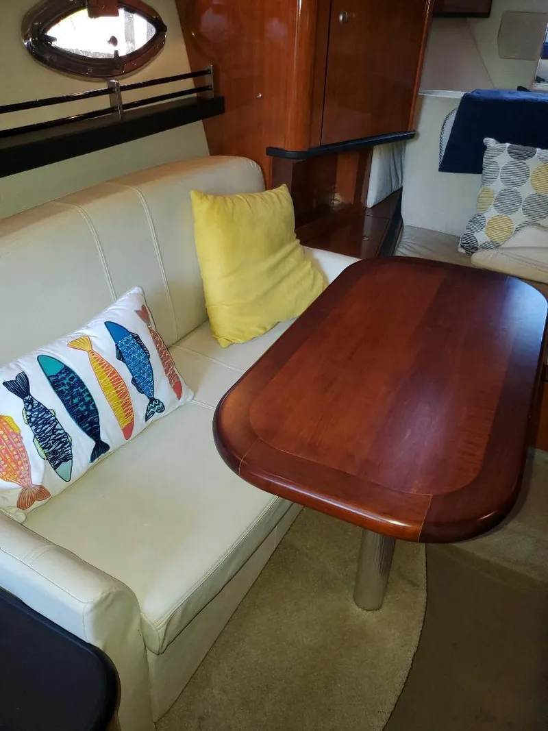 Slide: The Image of Interior of 2007 Sea Ray 290 Sundancer with cozy seating and decorative pillows. - 22