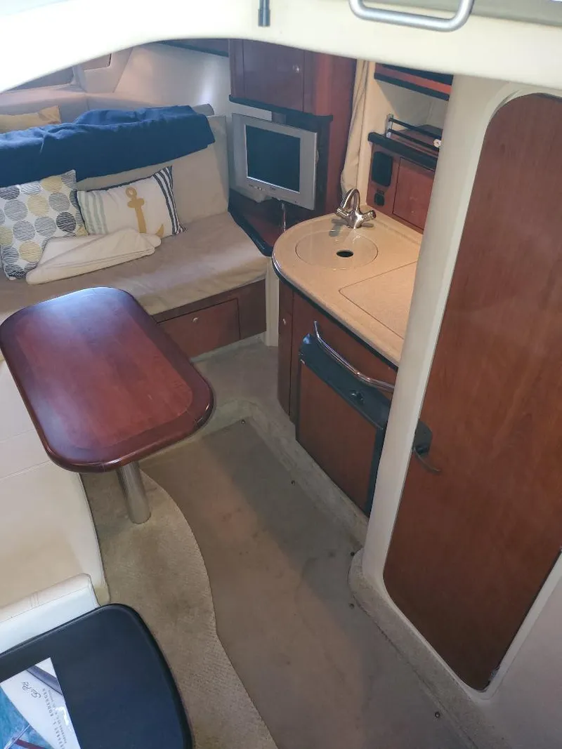 Slide: The Image of 2007 Sea Ray 290 Sundancer cabin interior with kitchenette, seating, and TV. - 23