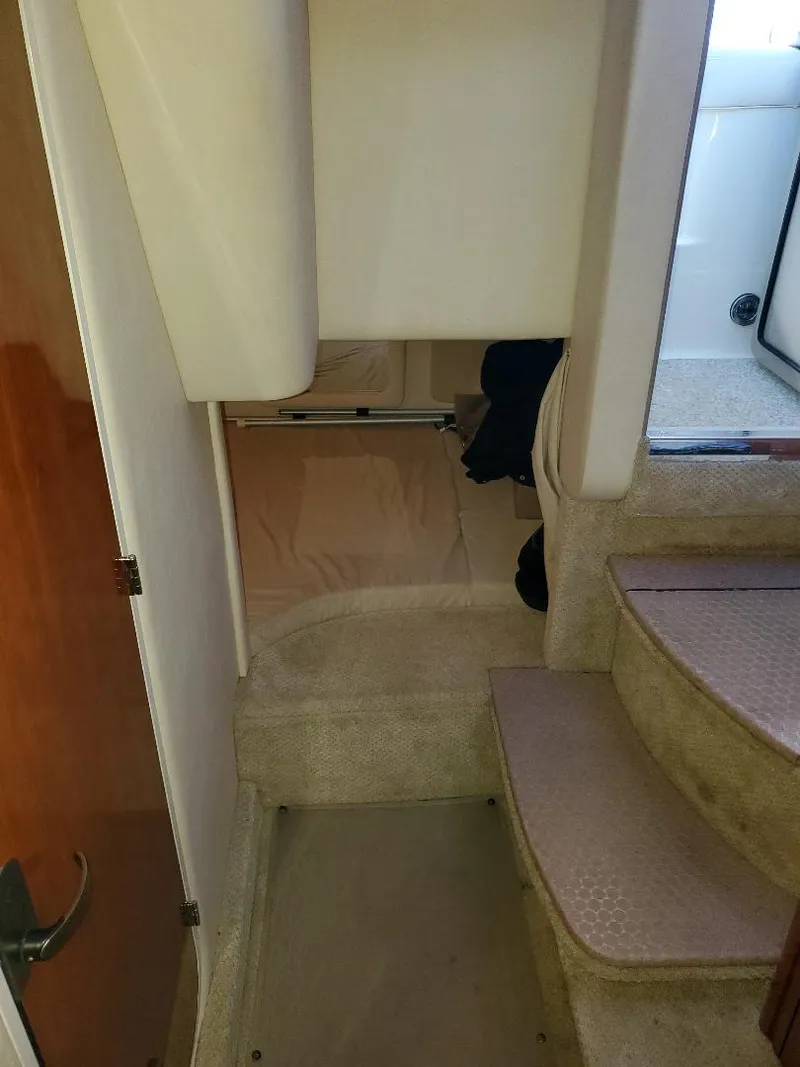 Slide: The Image of Interior cabin of 2007 Sea Ray 290 Sundancer with carpeted steps and cozy layout. - 24