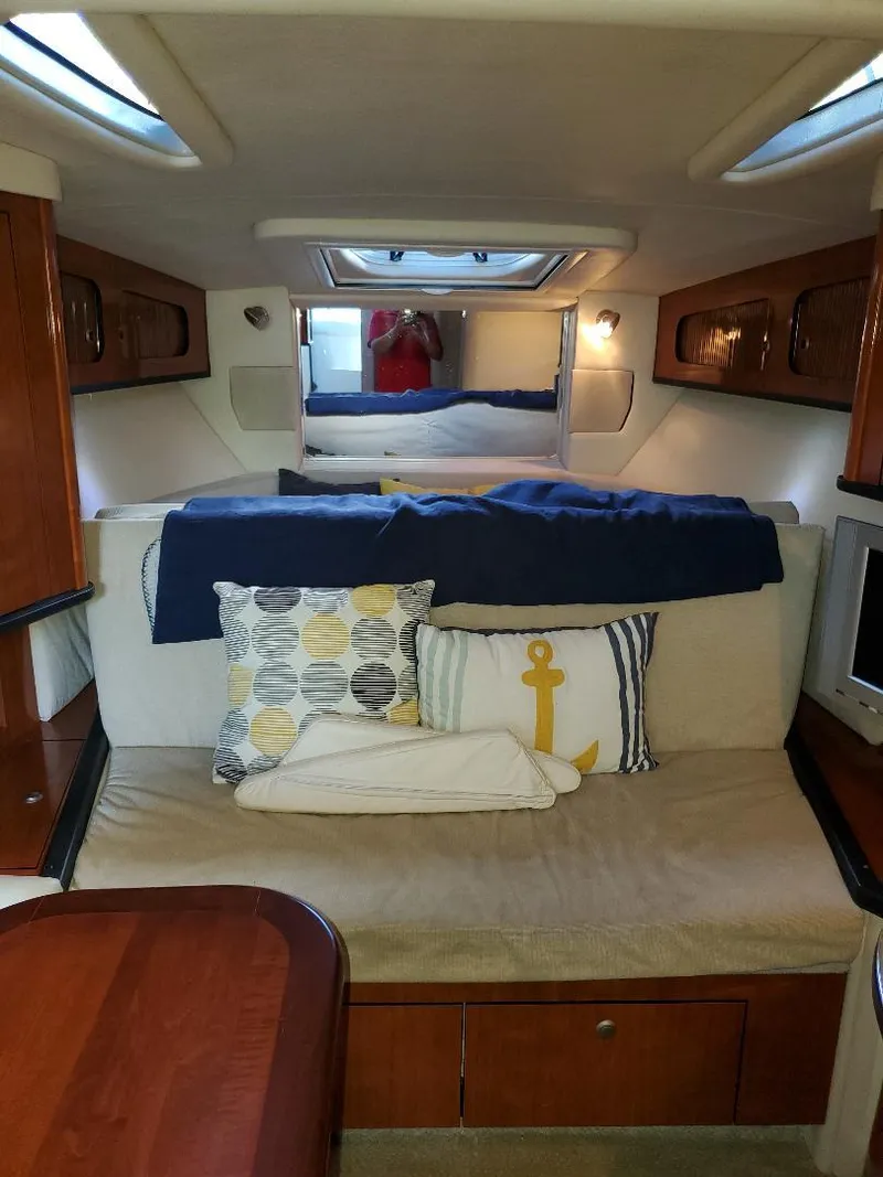 Slide: The Image of Interior of 2007 Sea Ray 290 Sundancer with cozy seating and nautical decor. - 26