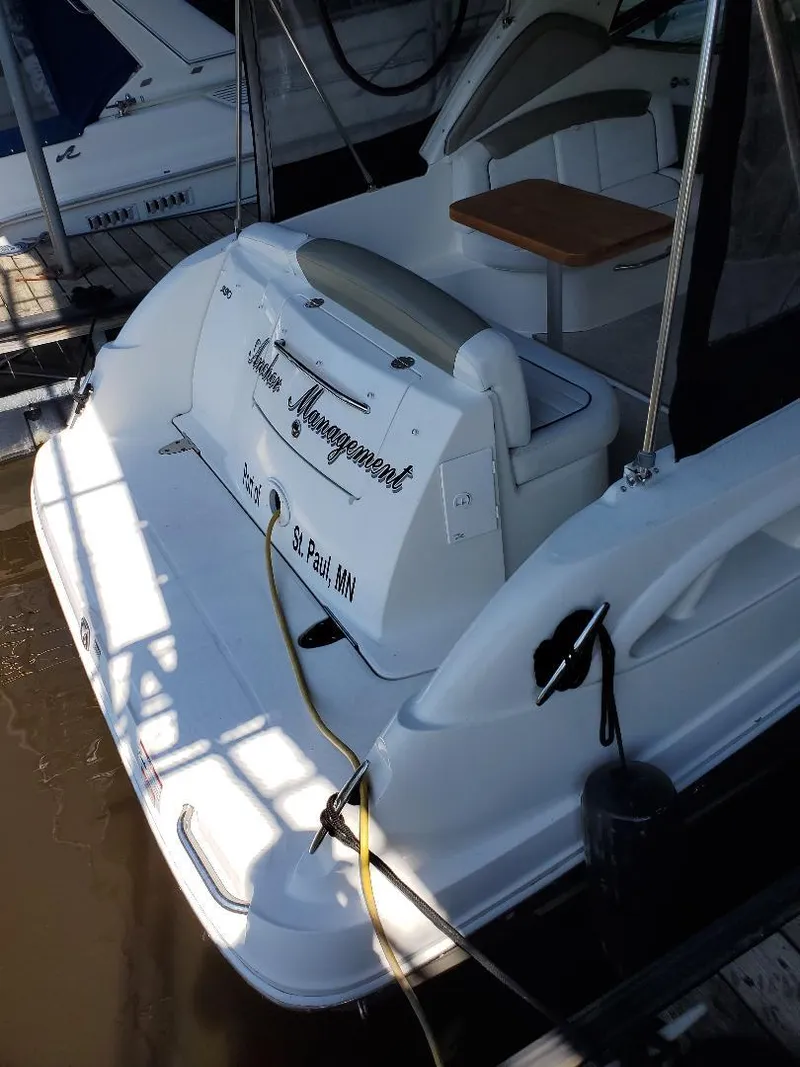 Slide: The Image of 2007 Sea Ray 290 Sundancer docked, featuring a spacious deck and seating area. - 27