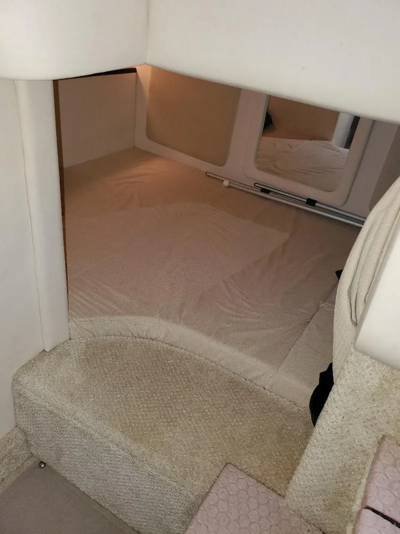 Slide: The Image of 2007 Sea Ray 290 Sundancer cabin interior with beige carpeting and bedding. - 29