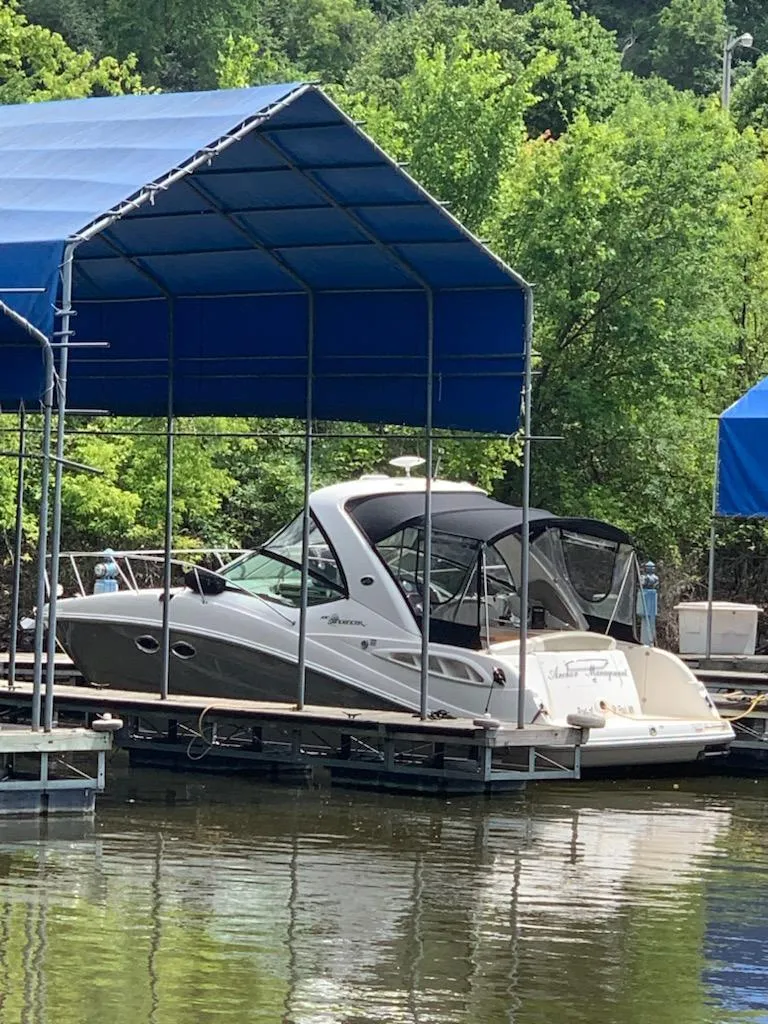 Slide: The Image of 2007 Sea Ray 290 Sundancer docked under blue canopy on a calm lake. - 5