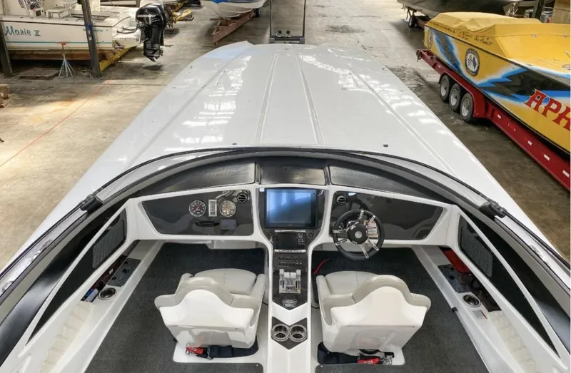 Slide: The Image of 2016 MTI 52' Pleasure boat interior with dual white seats and modern dashboard. - 8