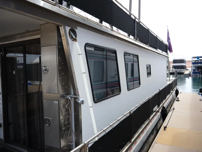 Slide: The Image of Custom 1999 55x14 Stainless Houseboat docked at marina. - 11