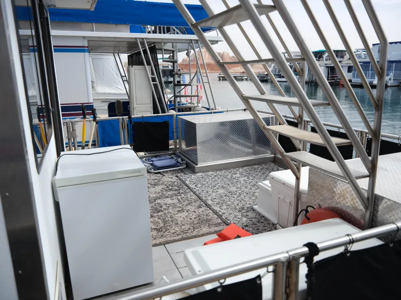 Slide: The Image of 1999 Custom 55x14 Stainless Houseboat deck with appliances and marina view. - 12