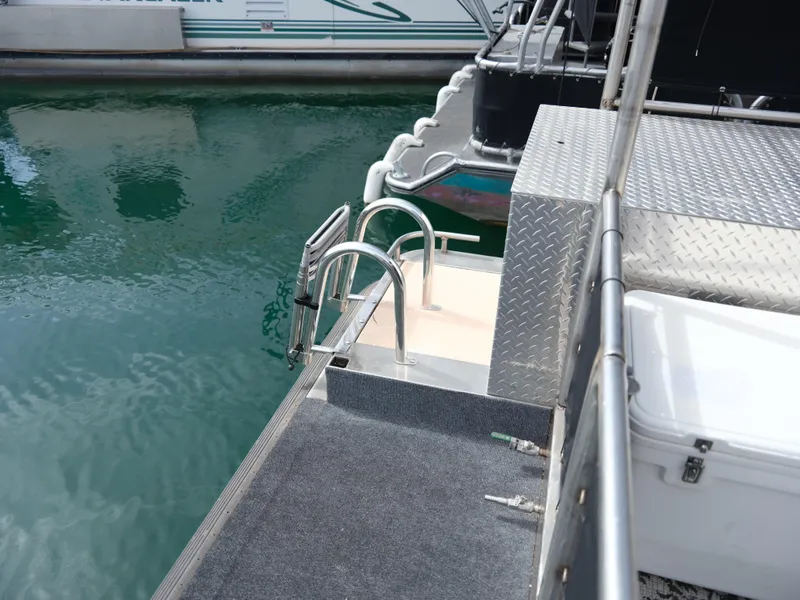 Slide: The Image of 1999 Custom 55x14 Stainless Houseboat with swim ladder and deck railing. - 14