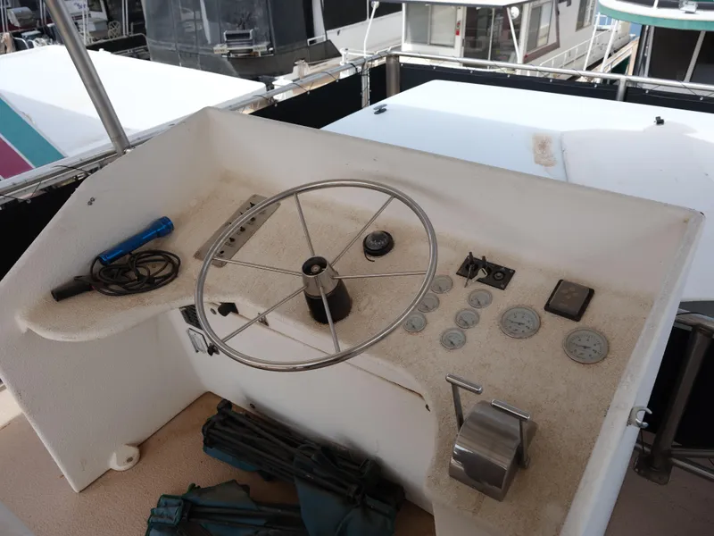 Slide: The Image of 1999 Custom 55x14 Stainless Houseboat helm with steering wheel and control panel. - 20