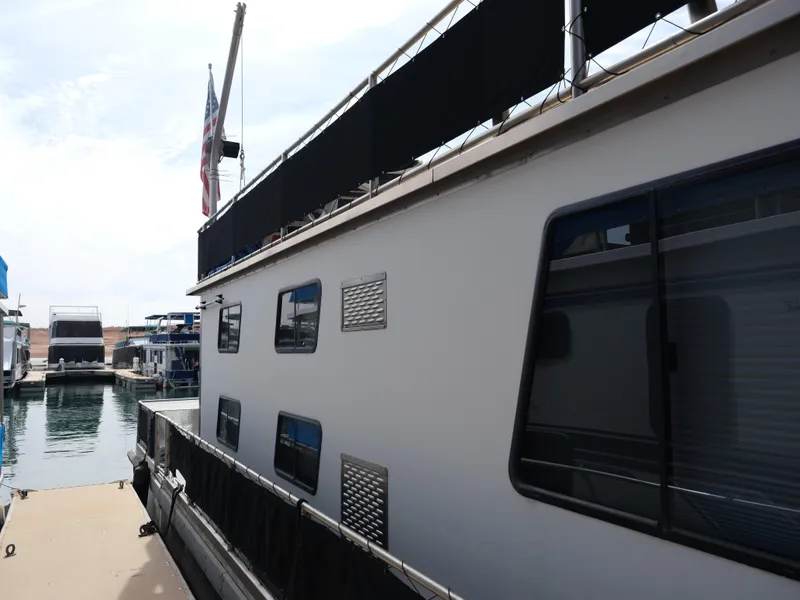 Slide: The Image of 1999 Custom 55x14 Stainless Houseboat docked at marina. - 22