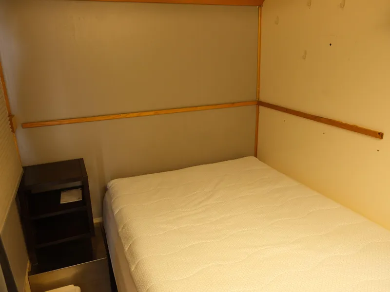 Slide: The Image of Small bedroom with a bed and nightstand on a 1999 Custom 55x14 Stainless Houseboat. - 32
