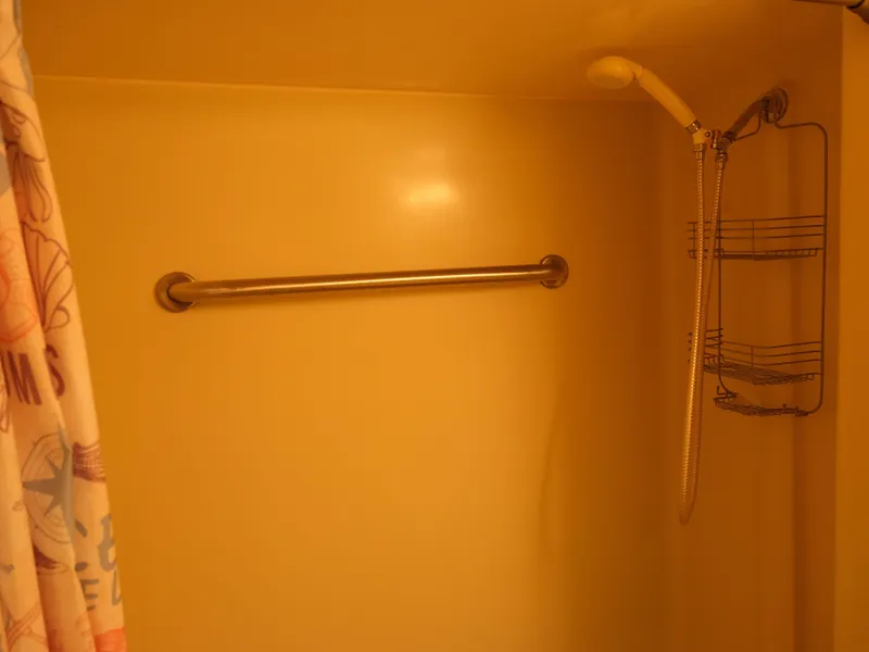 Slide: The Image of Houseboat bathroom with shower, stainless steel grab bar, and shower caddy. - 33