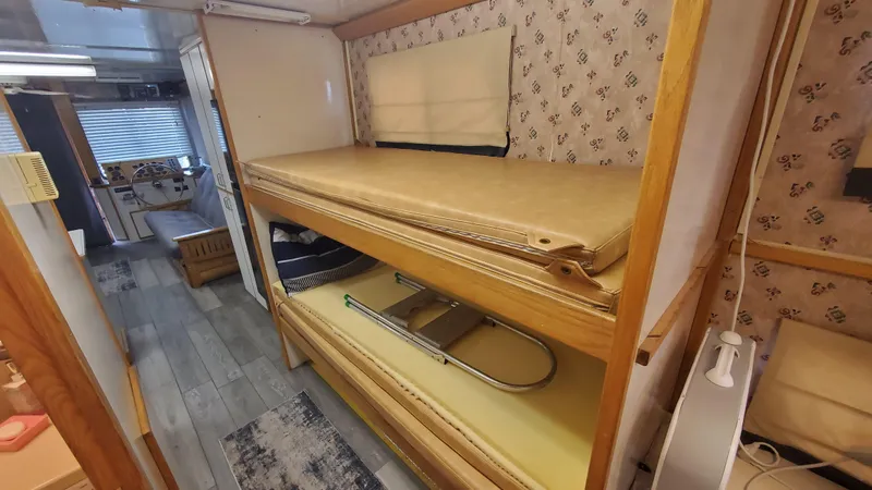 Slide: The Image of Interior of 1999 Custom 55x14 Stainless Houseboat with bunk beds and nautical decor. - 4