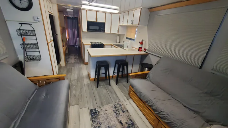 Slide: The Image of Interior of a 1999 Custom 55x14 Stainless Houseboat with modern kitchen and seating area. - 7