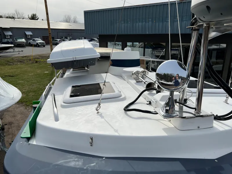 Slide: The Image of 2013 Ranger Tugs R-27 boat deck with equipment and hatch, docked near buildings. - 21