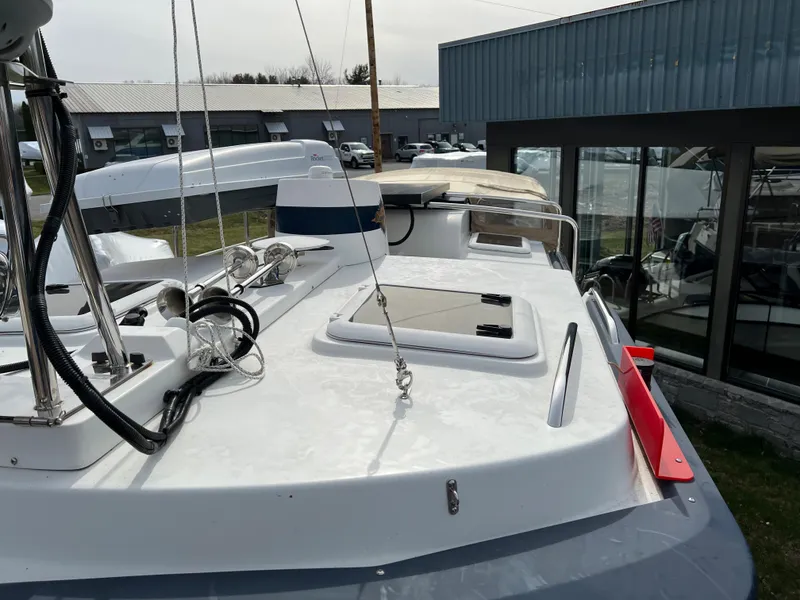 Slide: The Image of 2013 Ranger Tugs R-27 boat deck with hatch and railing, docked near a building. - 22