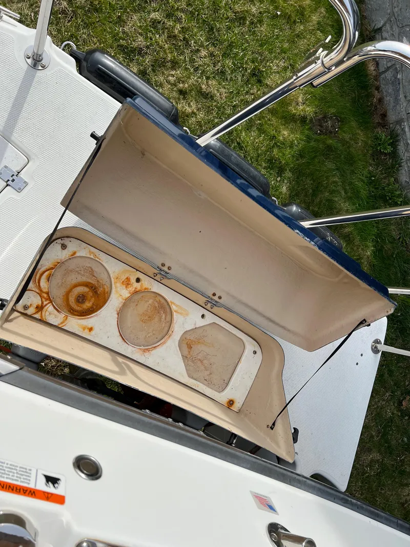 Slide: The Image of Open storage compartment on 2013 Ranger Tugs R-27 boat, showing rusted interior. - 23