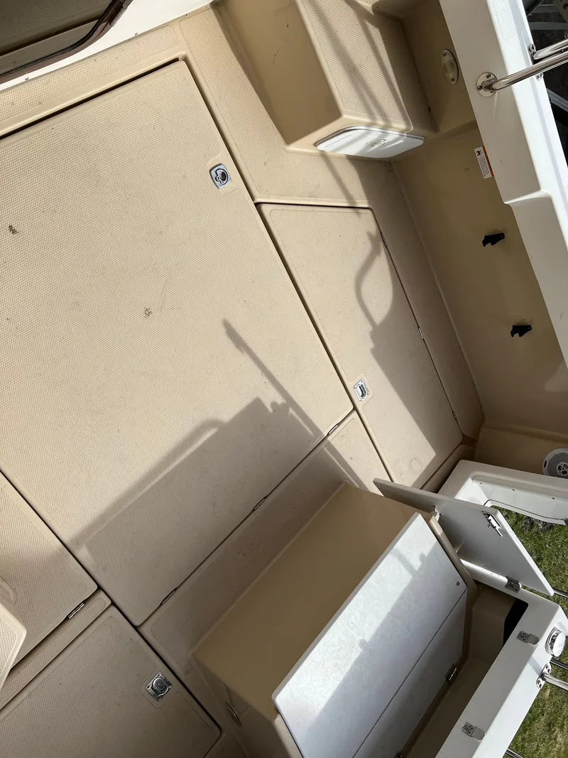 Slide: The Image of 2013 Ranger Tugs R-27 boat deck with storage compartments. - 24